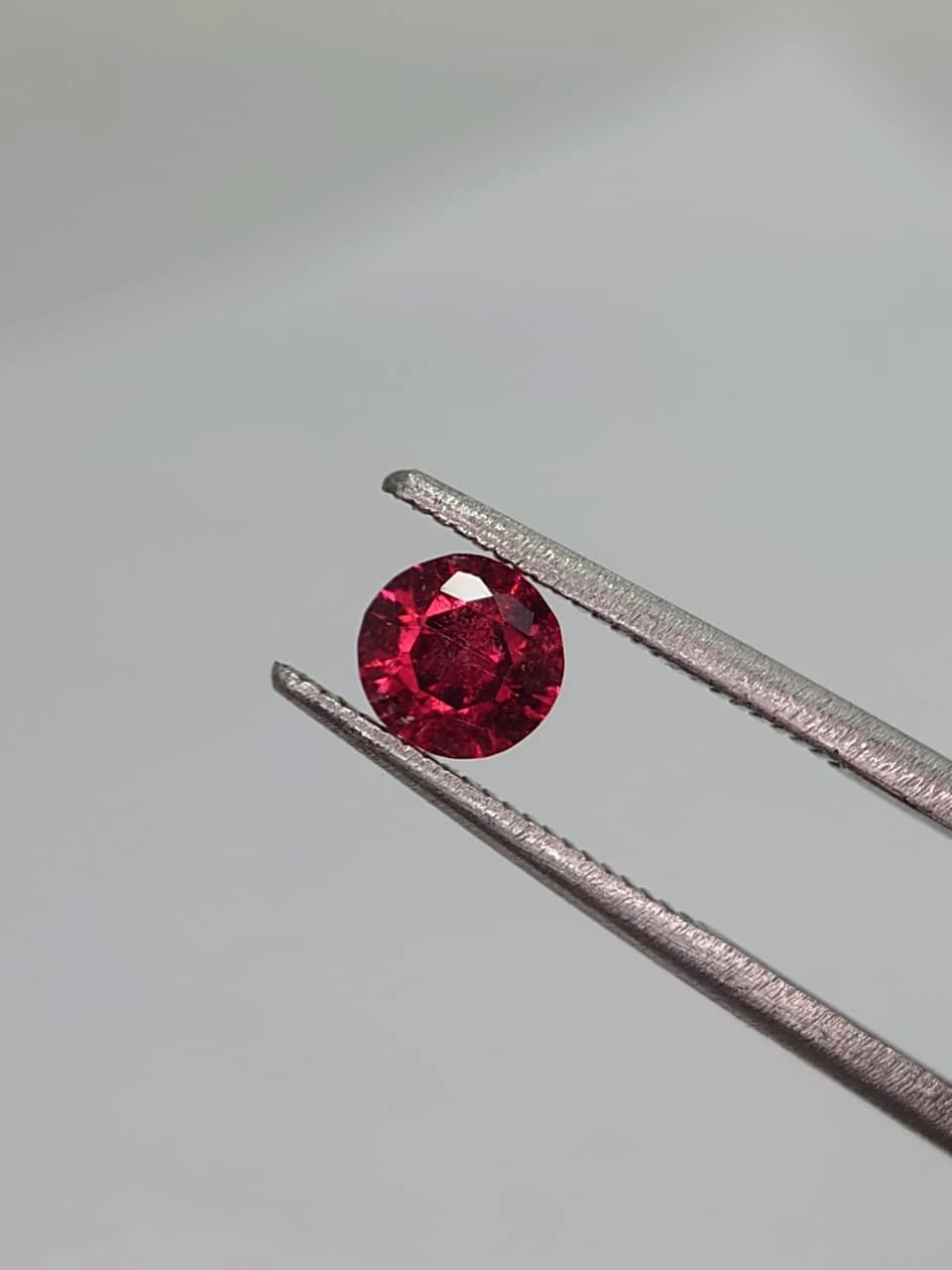 0.6ct Natural Round Faceted Malaya Garnet from Tanzania — view 5